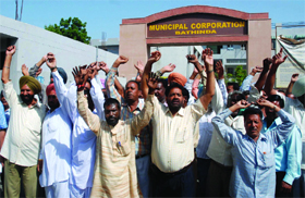 Up in arms: Members of the Municipal Corporation Workers Union staging a protest demonstration in Bathinda on Tuesday. 