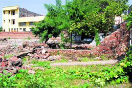 A demolished structure on a green belt behind Phase 3 B 1, Mohali, on Tuesday.
