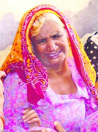A wailing relative of the victims at Kabulpur village