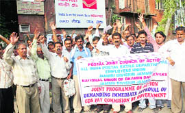 Employees of the Department of Posts hold a protest in Jammu on Tuesday.