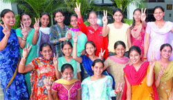 University toppers of Kanya Maha Vidyalaya show the victory sign on the college campus in Jalandhar.