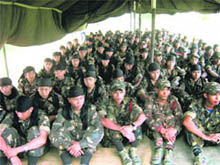Black Widow cadres gather to lay down their arms before the police at Sontilla in Assam on Tuesday. 