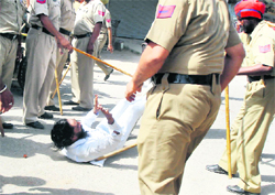 Policemen beat up a farmer outside the office of the Deputy Commissioner,Tarn Taran, on Tuesday.