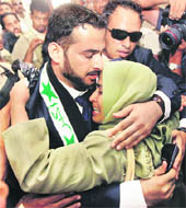 Iraqi reporter Muntazer al-Zaidi embraces his sister upon arrival at the Al-Baghdadya television station following his release from prison in Baghdad on Tuesday.