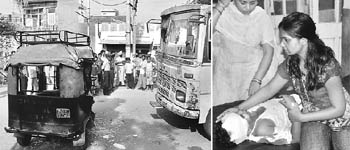 An autorickshaw that overturned, injuring three children and a driver, after a collision with a bus; and (right) a relative attends to an injured child in Patiala on Wednesday.