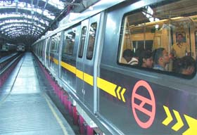 Journalists attend a briefing on board a new broad gauge Metro coach during a preview in New Delhi
