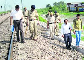 Members of the FSL inspect the attack site near the Gharunda railway station