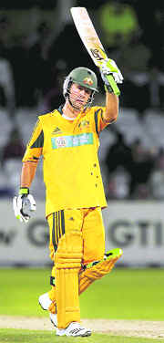 Ricky Ponting raises his bat after reaching his century on Tuesday. 