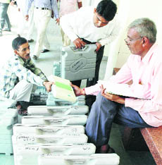 Election officials inspect electronic voting machines at the mini-secretariat in Gurgaon on Thursday.