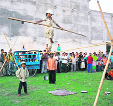 A minor girl perfoms a balancing act on a rope in Karnal.