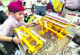 A child looks at sophisticated farm equipment on display at Kisan Mela that began at the PAU in Ludhiana on Thursday.