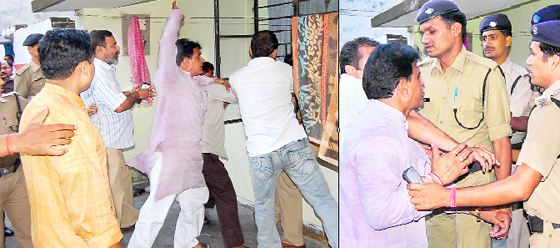 Agitated Hindu Jagran Manch workers assault a policeman at a police station in Haridwar on Thursday evening.