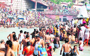 Devotees take a dip at Har ki Pauri in Haridwar on Friday.