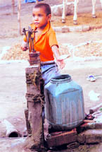 A boy in Batra Colony draws water from an unsafe source.