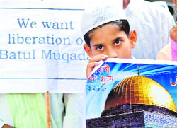A boy holds a poster during a protest seeking liberation of the Palestinian territory occupied by Israel, in New Delhi on Friday.