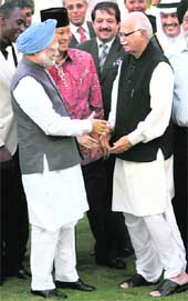Prime Minister Manmohan Singh greets Leader of the Opposition LK Advani at an Iftaar hosted by him in New Delhi on Friday.