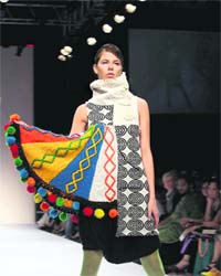 A model walks the ramp displaying the collection of Gen Next on the second day of Lakme Fashion Week in Mumbai