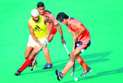 Players vie for the ball during a match at Hockey Stadium, Sector 42, Chandigarh, on Saturday.