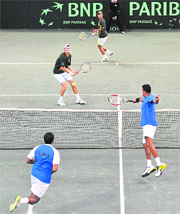 Rohan Bopanna (L) and Mahesh Bhupathi in action against South Africas Wesley Moddie (C) and Jeff Ceotzee (up) at Ellis Park Indoor Arena in Johannesburg on Saturday.