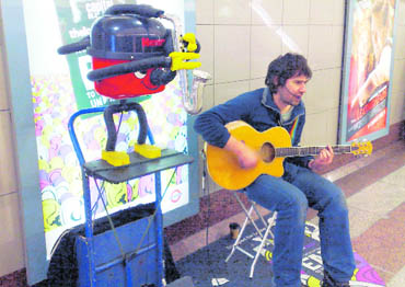 The star attraction of busker Steve Arunis performance is Henry, his robotic vacuum cleaner, which plays the saxophone
