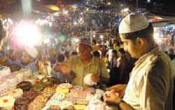 A vendor sells caps on the eve of Id-ul-Fitr at Jama Masjid in New Delhi on Sunday.