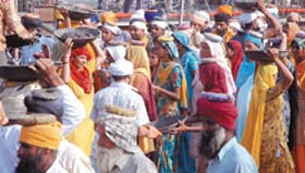 Devotees perform kar seva for a parking lot at Bangla Sahib Gurdwara in New Delhi on Sunday.