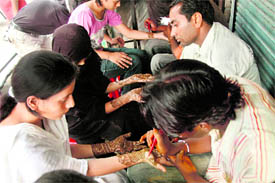 Muslim girls get mehndi applied on their hands for Eid in Dehradun on Sunday.