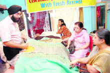 Customers have a look at Kashmiri fabrics displayed at the Kashmiri exhibition in Dehradun.