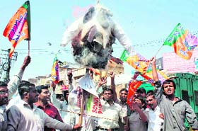 Members of the youth wing of the BJP burn an effigy of Vijay Goel, in charge of the party affairs in Haryana, in protest against the alleged sale of the party ticket, in Gurgaon on Sunday.