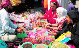 Women shop for Id-ul-Fitr in Srinagar on Sunday.