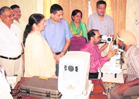 A doctor examines a patient during an eye check-up camp at Ahmedgarh