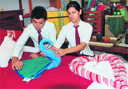 Students teach how to make forms out of towels