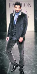 Actor John Abraham displays creation by Rocky S at the Lakme Fashion Week in Mumbai on Sunday night. 
