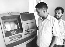 Consumers at an ATM in Rajpura on Monday. 