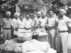 Policemen with confiscated booty of firecrackers in Rajpura on Monday. 