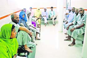 Patients wait for their turn outside the OPD of the Rohtak PGIMS