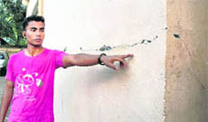 A man shows the cracks on a wall of an apartment following an earthquake in Guwahati on Monday.