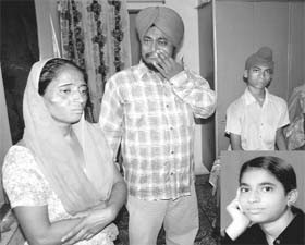 Grieving relatives of Preeti (inset), who committed suicide, in Rajpura