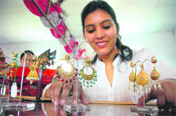 A girl chooses earrings at an exhibition in the Rotary Club, Jammu. 
