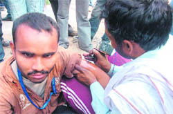 A tattoo being etched on the arm of a devotee in Katra.