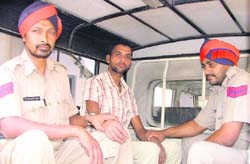 The accused, who made hoax calls, being taken to a court. 
