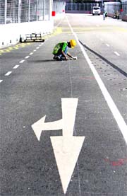 A worker checks the track of the Singapore F1 Grand Prix at the Marina Bay street circuit on Wednesday.