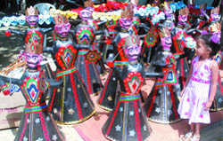 A girl looks at Ravana idols at Blind School, Lodhi Road in New Delhi 