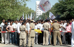 Police personnel try to control supporters of former INLD leader Sukhbir Kataria, who is contesting as an Independent from the Gurgaon Assembly constituency, in Gurgaon