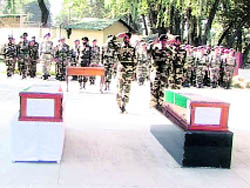 Army personnel salute the coffins of Major Suresh Suri.