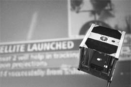 A demonstration version of the SwissCube satellite is pictured during the live projection of the launch of the satellite from the Sriharikota space base, at the Federal Institute of Technology (EPFL) in Lausanne on September 23, 2009.