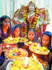 School girls offer prayers on the occasion of Durga Puja in Amritsar. 