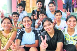 Winners of badminton meet in jubilant mood in Mohali on Friday.