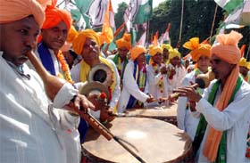 Folk artistes perform as Congress nominee from Badshahpur Assembly segment Rao Dharampal goes to file his nomination papers in Gurgaon on Friday. 