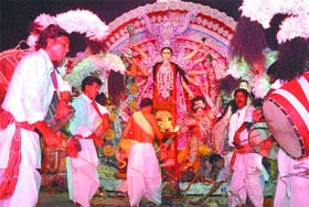 A priest performs aarti on the saptami puja at Aram Bagh Puja Samiti in New Delhi on Friday.